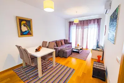 a living room with a table and a couch at Sun and Sea I in Caniço