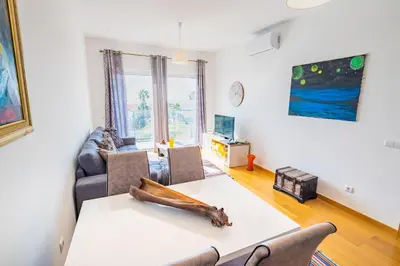 a living room with a table and chairs at Sun and Sea I in Caniço