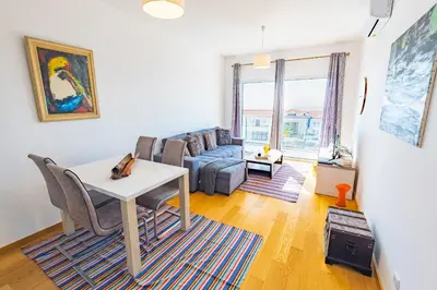 a living room with a table and a couch at Sun and Sea I in Caniço