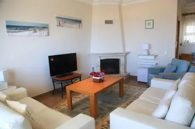 a living room with a couch and a table at Vila G, Mira Luz in Luz