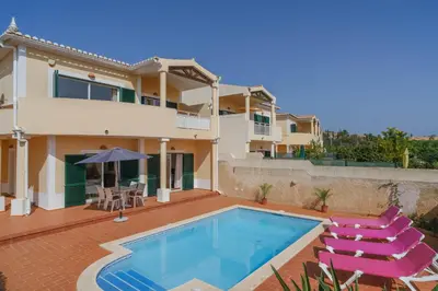 a villa with a swimming pool and a house at Vila Bela Nova Acácias 22 in Luz