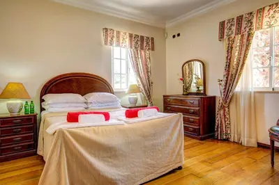 a bedroom with a large bed with red pillows at Villa Daisy by Villa Plus in Lagos
