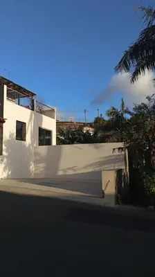 a white fence in front of a white building at Vаrаndаs dо Sоl-Vista relaxante entre mar e montanha in Ponta do Sol