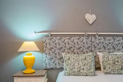 a bedroom with a bed with a heart on the wall at Casa do Cais in Calheta