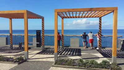a group of people looking at the ocean at Casa do Cais in Calheta