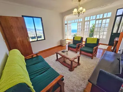 a living room with a couch and chairs and a table at Maria Cottage Levada do Norte WiFi in Câmara de Lobos