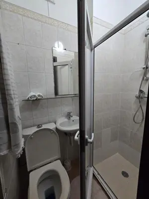 a bathroom with a toilet and a sink and a shower at Maria Cottage Levada do Norte WiFi in Câmara de Lobos
