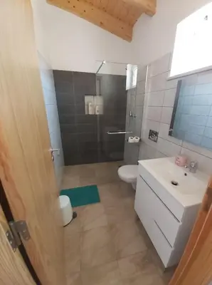 a bathroom with a toilet and a sink and a shower at Monte Bagão - Turismo Rural in Vila do Bispo