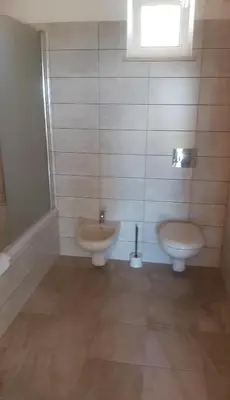 a bathroom with a toilet and a bidet and a sink at Monte Bagão - Turismo Rural in Vila do Bispo