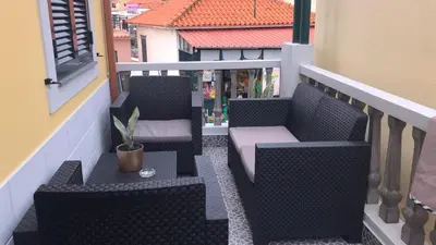 two chairs and a table on a balcony at Casas do Baleeiro - Whaler's Houses by Rentery Madeira in Caniçal