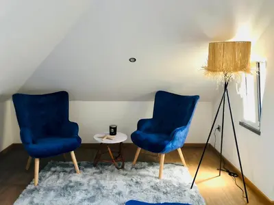 two blue chairs and a table in a room at Casas do Baleeiro - Whaler's Houses by Rentery Madeira in Caniçal