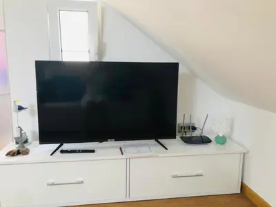 a television on a white dresser in a room at Casas do Baleeiro - Whaler's Houses by Rentery Madeira in Caniçal