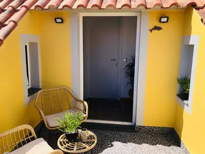 a front porch with a chair and a door at Casas do Baleeiro - Whaler's Houses by Rentery Madeira in Caniçal