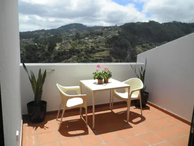 a table and chairs on a balcony with a view at Villa Luz II - NEW - Private Outdoor Area in Santa Cruz