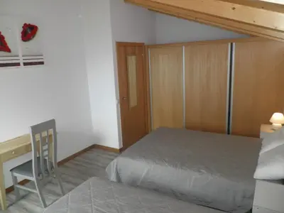 a bedroom with a bed and a desk and a chair at Villa Luz II - NEW - Private Outdoor Area in Santa Cruz