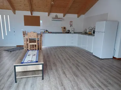 a kitchen with a counter and a table and a refrigerator at Villa Luz II - NEW - Private Outdoor Area in Santa Cruz