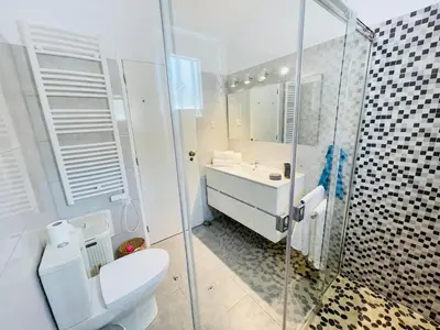 a bedroom with a bed and a door to a patio at Vila Vista Luz in Lagos