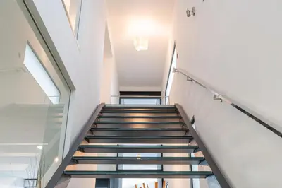 a staircase in a building with glass floors at Sunshine Villa with Optionally Heated Pool 150m above Ocean & Sandy Beach in Estreito da Calheta