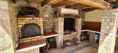 a large brick oven in a building with a brick at Catavento in Porto Santo