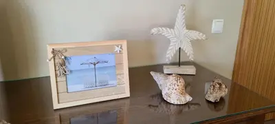 a table with a picture and two figurines on it at Catavento in Porto Santo