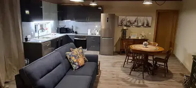 a living room with a couch and a table in a kitchen at Catavento in Porto Santo