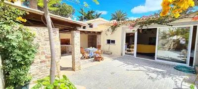 a patio of a house with a table at Catavento in Porto Santo