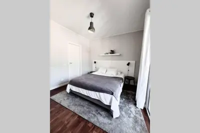 a bedroom with a bed with a gray blanket at Santa Luzia's Pearl VI - Two Bed Apartment in Funchal