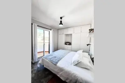 a white bedroom with a bed and a window at Santa Luzia's Pearl VI - Two Bed Apartment in Funchal