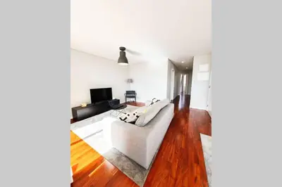 a living room with a white couch and a television at Santa Luzia's Pearl VI - Two Bed Apartment in Funchal