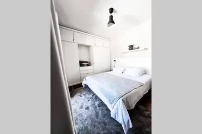 a bedroom with a white bed with a blue carpet at Santa Luzia's Pearl VI - Two Bed Apartment in Funchal