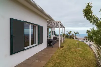 a house with a balcony with a view of the ocean at Vila da Falésia-With Pool and views in Caniço