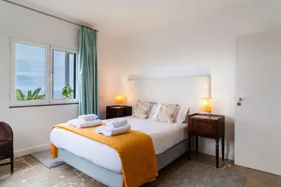 a bedroom with a bed with two towels on it at Vila da Falésia-With Pool and views in Caniço