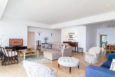 a living room with a couch and a table at Vila da Falésia-With Pool and views in Caniço