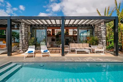 a villa with a swimming pool and a house at OurMadeira - Garden Paradise in Calheta