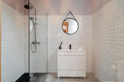 a white bathroom with a sink and a mirror at OurMadeira - Garden Paradise in Calheta