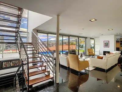 a living room with a spiral staircase in a house at The White House - By LovelyStay in Funchal