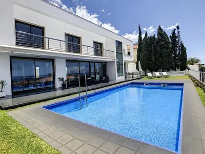 a swimming pool in front of a house at The White House - By LovelyStay in Funchal