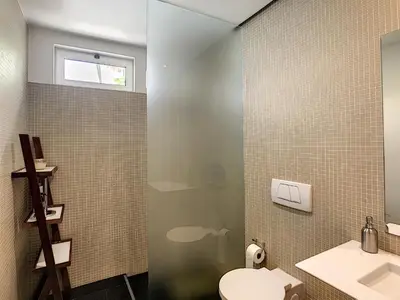 a bathroom with a shower and a toilet and a sink at The White House - By LovelyStay in Funchal