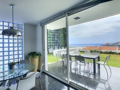 a dining room with a view of the ocean at The White House - By LovelyStay in Funchal