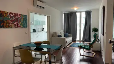 a living room with a dining room table and chairs at Funchal Centrum Apartment in Funchal