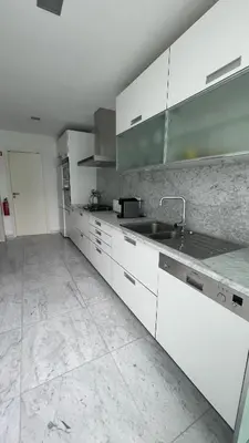 a kitchen with white cabinets and a sink at Funchal Centrum Apartment in Funchal
