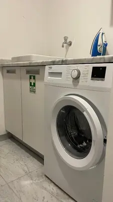 a washing machine in a room with a sink at Funchal Centrum Apartment in Funchal