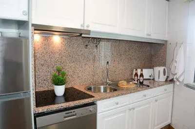 a kitchen with a sink and a counter top at Sol do Lido in Funchal
