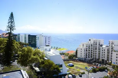 an aerial view of a city with the ocean at Sol do Lido in Funchal