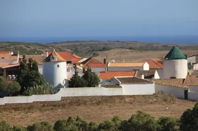 a small town with white buildings and red roofs at Casa das Flores in Vila do Bispo