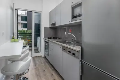 a white kitchen with a sink and a counter at FLH Funchal Nature Flat with Balcony in Funchal