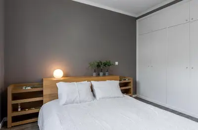 a bedroom with a white bed with a wooden headboard at FLH Funchal Nature Flat with Balcony in Funchal