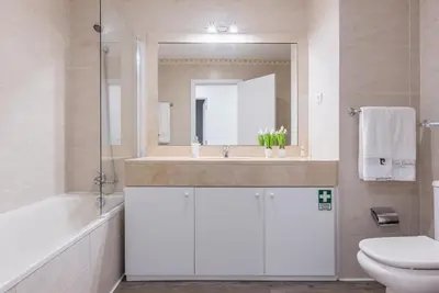 a bathroom with a sink and a toilet and a mirror at FLH Funchal Nature Flat with Balcony in Funchal