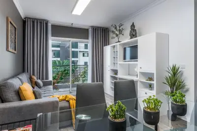 a living room with a couch and a glass table at FLH Funchal Nature Flat with Balcony in Funchal