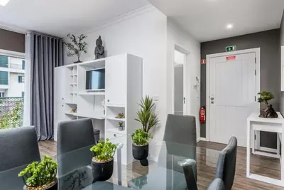 a dining room with a glass table and chairs at FLH Funchal Nature Flat with Balcony in Funchal